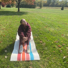 Load image into Gallery viewer, white blonde female on a stripe yoga mat at the park
